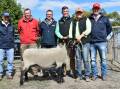 Allendale stud's Graham and Alastair Day (right), Elders' Ross Milne, Spence Dix & Co's Jono Spence and Nutrien' Andrew Wilson with Keeley Murch, Bordertown, holding the $5000 equal top priced ewe. The proceeds from the lot 51 ewe were donated to the Royal Flying Doctor Service.