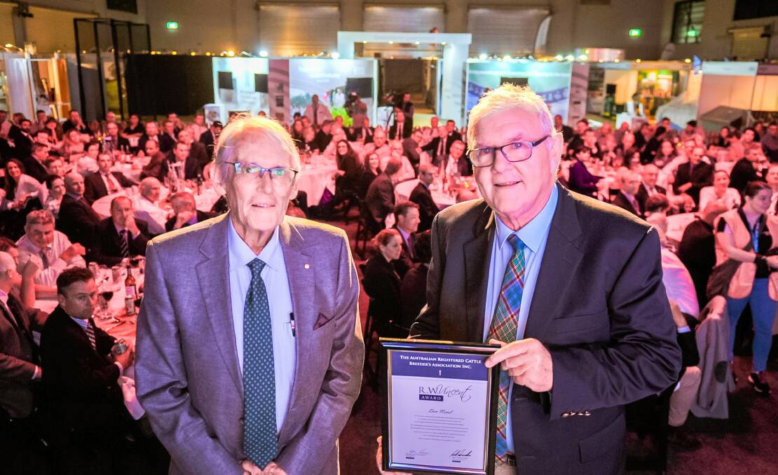 Dr Arthur Rickards, president of the Australian Registered Cattle Breeders Association, prevents cattle consultant Don Nicol with the prestigious R W Vincent Award at a gala dinner at Beef Australia in Rockhampton.