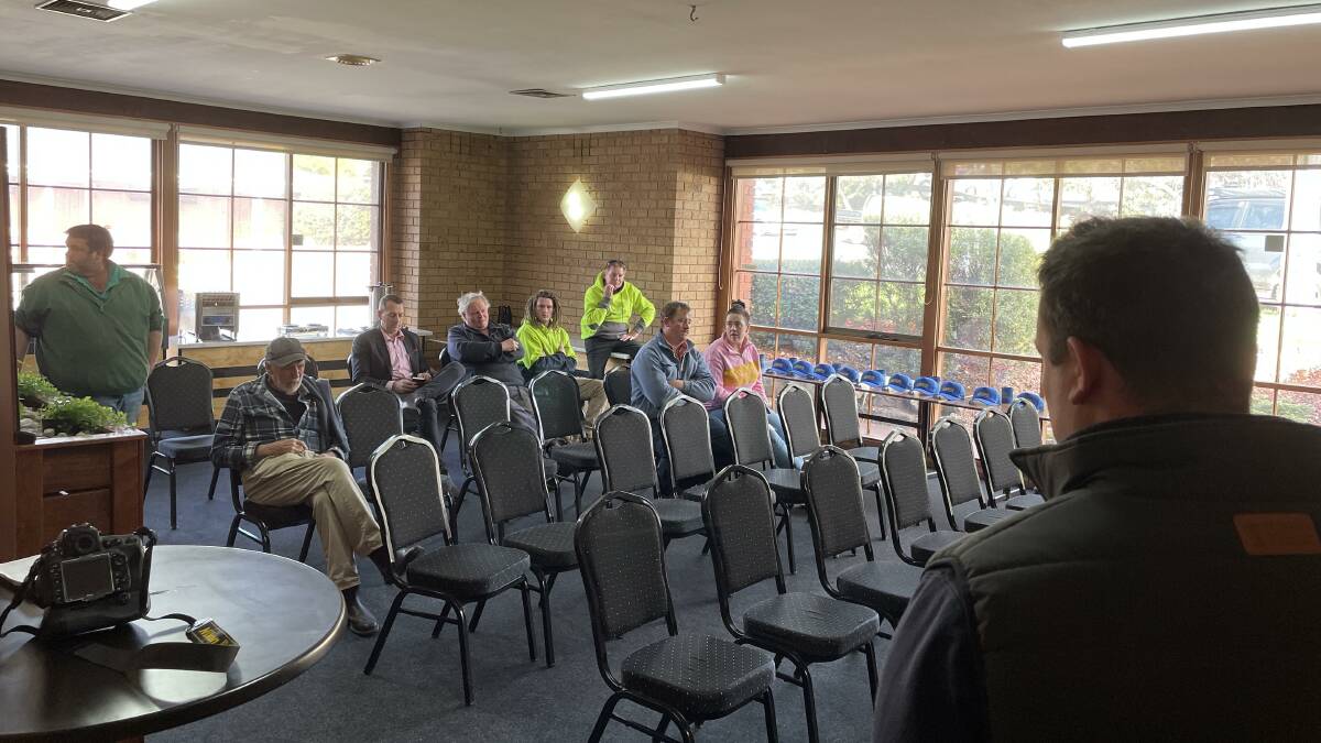 Mick Roche is pictured standing to the left at a public auction for farm land at Ararat in western Victoria held in late July.
