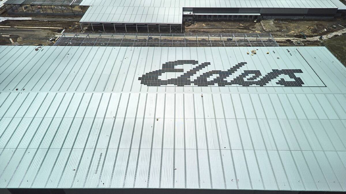 Solar panels have been arranged on the new building's roof to spell out the company name.