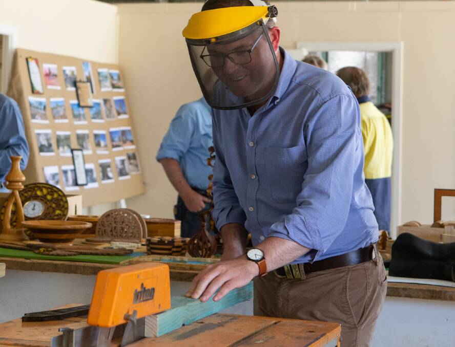 Northern Tablelands MP Adam Marshall, who secured the funds for Moree Mens Shed tries out some of the gear.