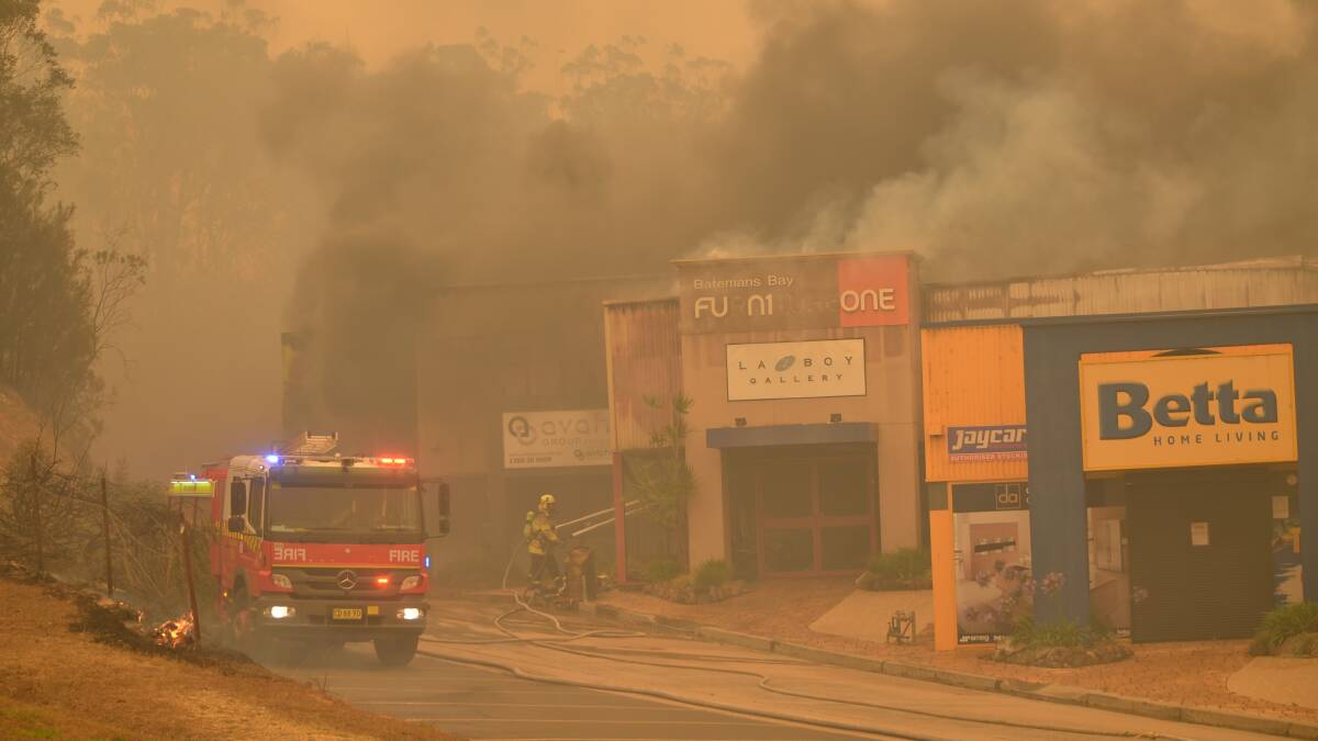  Firefighters work to save businesses at Batemans Bay. Picture: Supplied