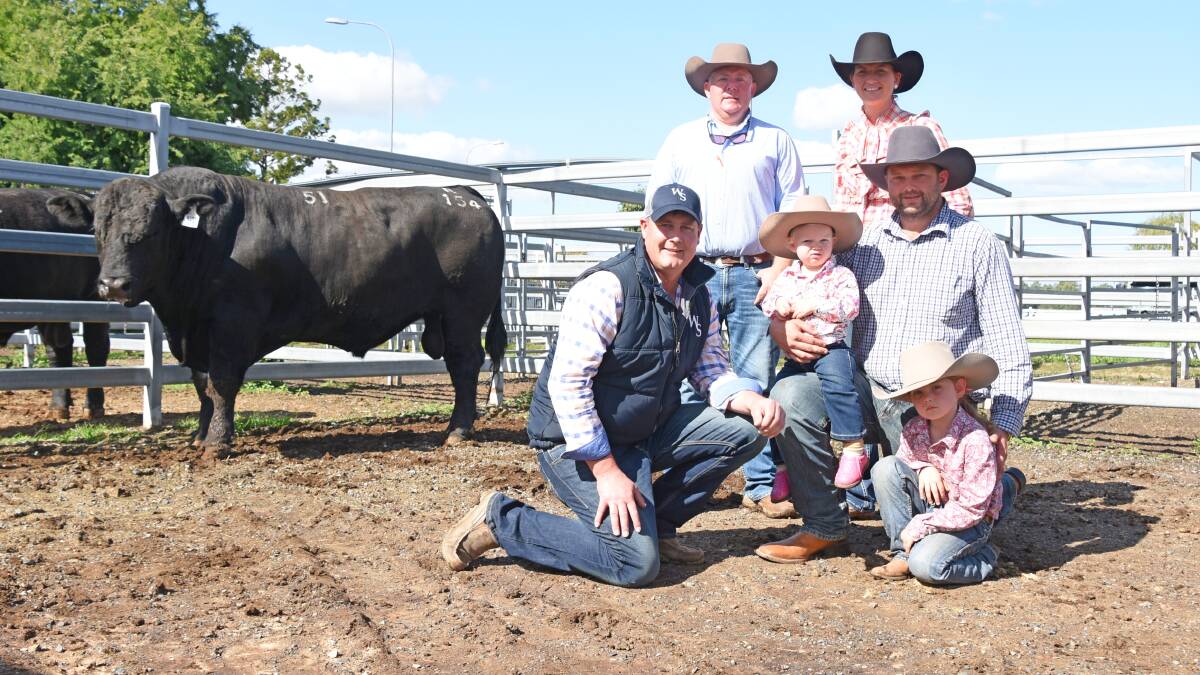 DEMAND: $24,000 Woonallee Ranch R154 pictured with Tom Wilding-Davies (back left) and Tom Baker (front left) Woonallee Simmentals, Millicent, SA, with purchases Becky and Damian with their two children Pippa and Anna Finger, Farlane Park, Middlemount, Queensland.