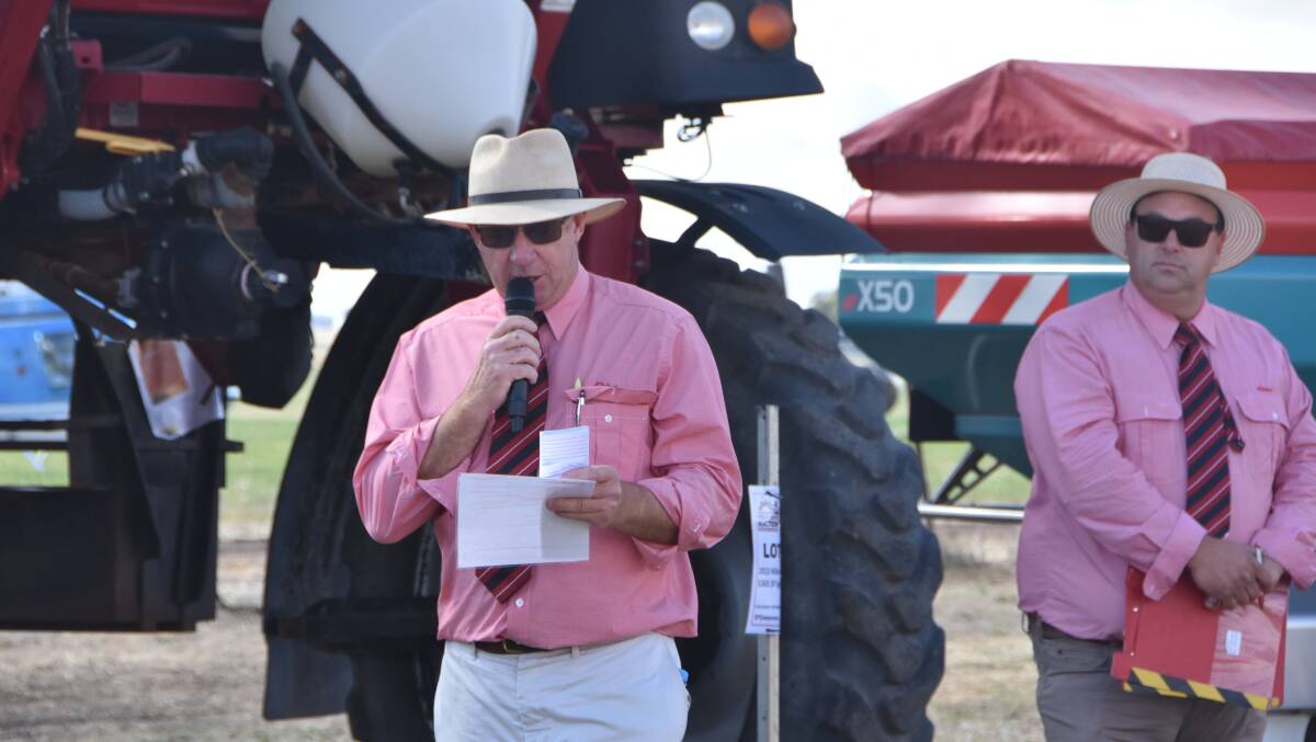 Andrew Adamson, Elders, welcomes the crowd to the first ever Wimmera Machinery Field Days clearing sale as Aaron Zwar watches on.
