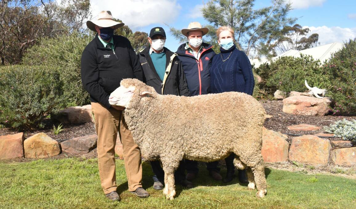 Physical sale: Nutrien Merino specialist Stephen Chalmers, with buyer of this Charinga ram for $21,000 at the on property ram auction last month, with John Humbert, Kedleston Park Merino stud, Calivil, and vendors Roger and Jo Polkinghorne, Charinga.