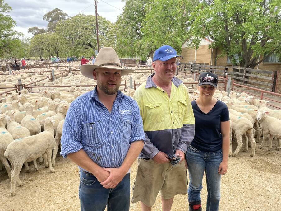 BENALLA: Rodwells auctioneer Adam Roberts with Bruce Kealey and daughter Rachel, Tamleugh, who purchased 104 first-cross ewe lambs from J & R Koop, Nioka for $255. 