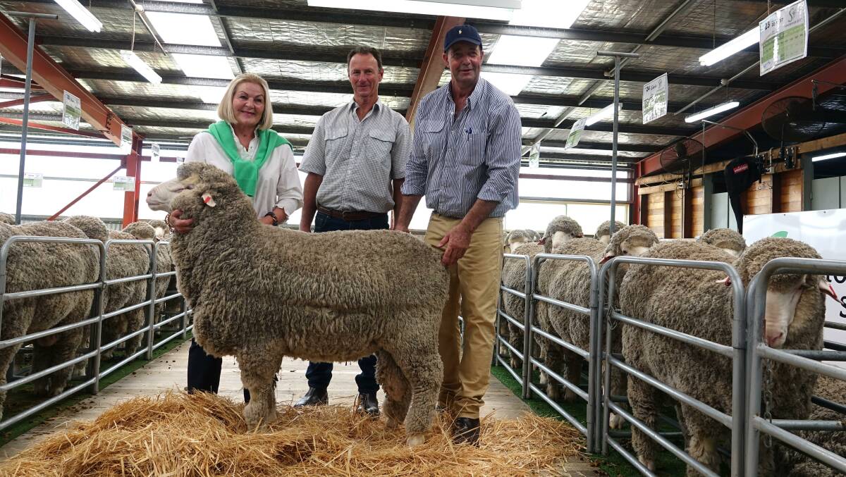 Lucy Gray, Melton Mowbray, Tas, John Williamson, Whorouly, and Stockman stud manager Kip Gray, Melton Mowbray, Tas, with the top-priced ram. Picture by Flea McShane
