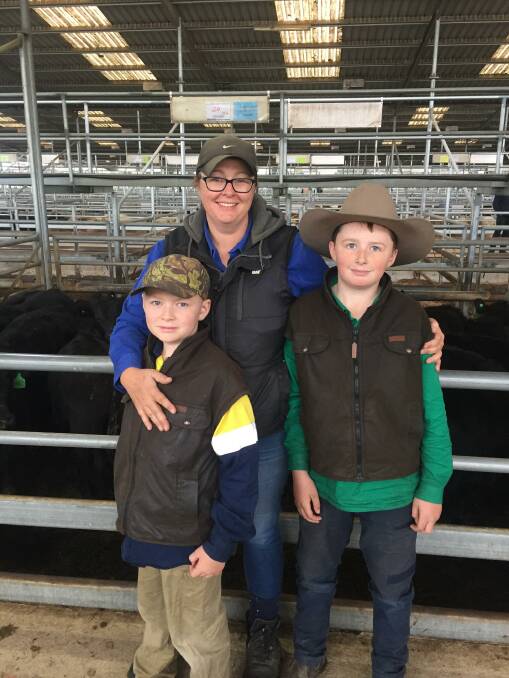 GOOD SALE: Kerri-Lee Whelan, with sons Riley and Archer, old 20 Angus steers, 327kg, for $1370, or 419c/kg.
