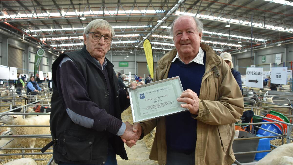 INDUSTRY HONOR: Greg Toll, who ran Gee Tee Wiltipolls, Gunbower, was given the award by Wiltipoll Stud Breeders Australia president, Ray Newman, at this year's Australian Sheep & Wool Show.