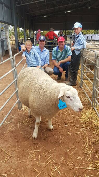 SALE-TOPPER: Lachie Rankin, with the top-priced ram, and Bridie, Chris and Rupert.