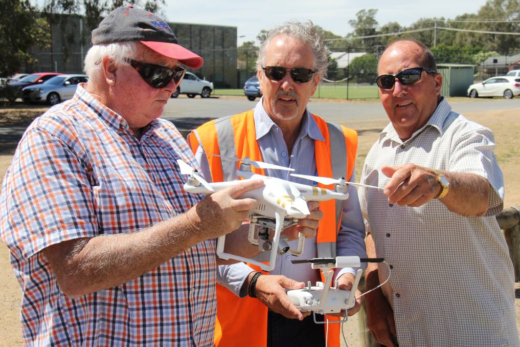 DRONE DISPLAY: Retired Numurkah farmers John Blackman and Ian Clark, with accredited drone pilot and GMW Draughting Officer Graeme Eadie. 