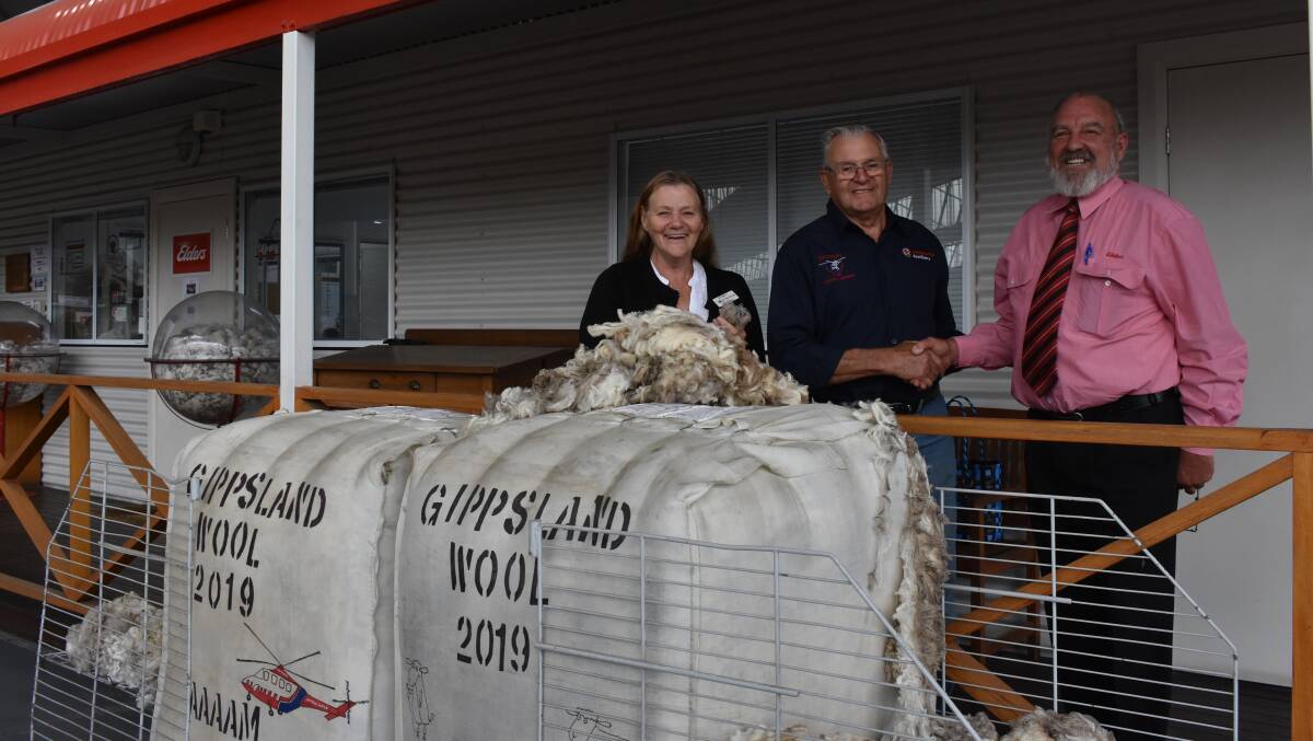 CHARITY AUCTION: The latest Elders Helimed charity wool auction has raised more than $13,000, here Elders Mal Nicolls congratulates Helimed auxiliary secretary Geoff Pollard and president Minke Bennett.