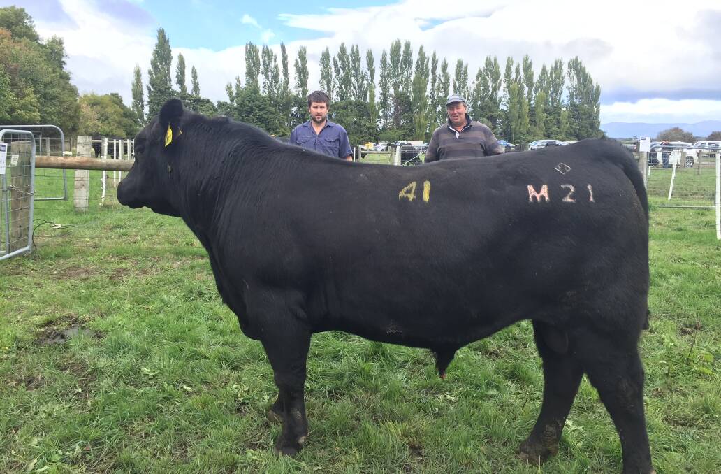 TOP BULL: Troy Johnson and Charles Knowles, Echo Cottage, with the top priced bull, Cluden Newry Reality M21 which sold for $14,000. 