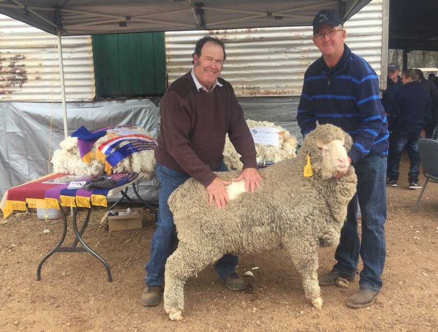 TOP RAM: Buyer Garry Griffin, with one of the two top priced Koole Vale rams, with stud co-principal, Alan Harris.