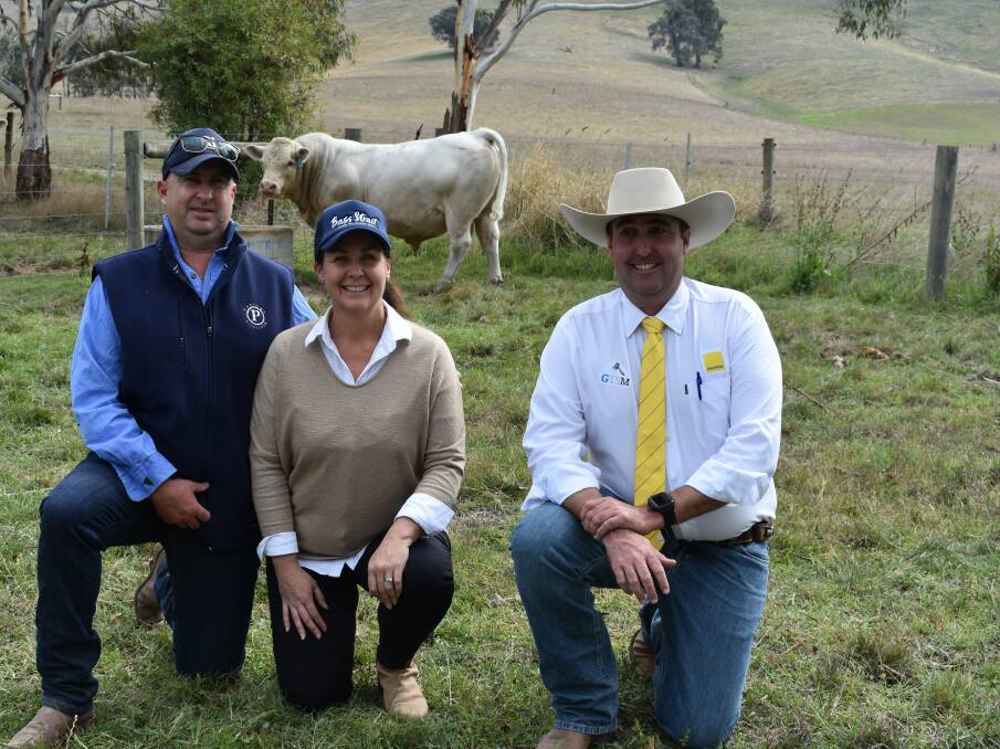 FINAL CHAROLAIS SALE: Paringa's Tom and Olivia Lawson, with Ray White GTSM livestock agent James Brown and the top-priced bull.