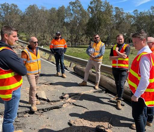 Roads Minister Ben Carroll (right) examines damage to the McIvor Highway, Axedale. Picture supplied by the Department of Transporrt.