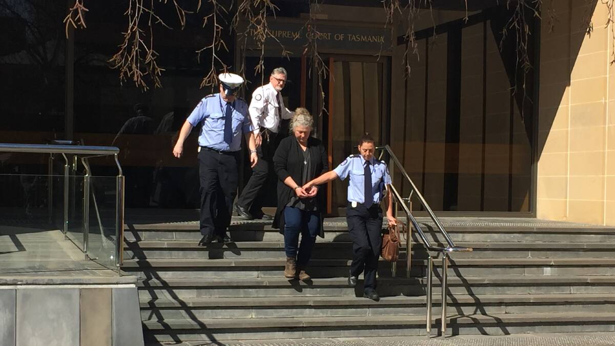 JAIL TIME: Letetia Anne Ware is escorted from the Hobart Supreme Court. Photo by Emily Jarvie. 