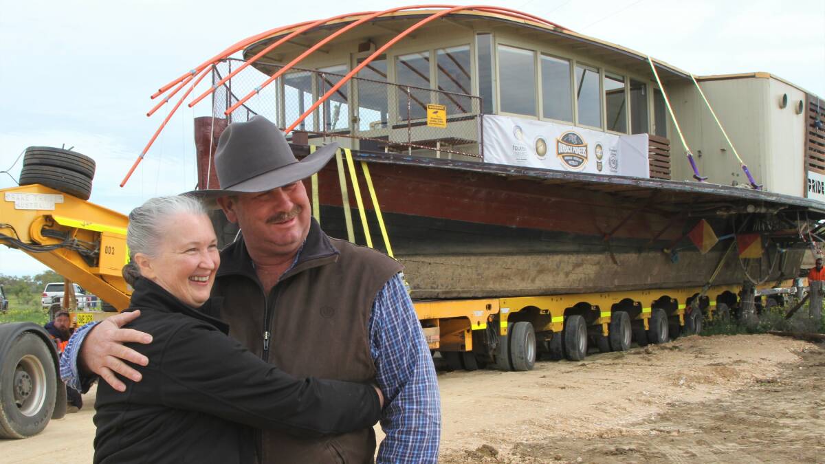 Marisse Kinnon hugs her husband Richard Kinnon at the conclusion of the epic journey from Echuca to Longreach.