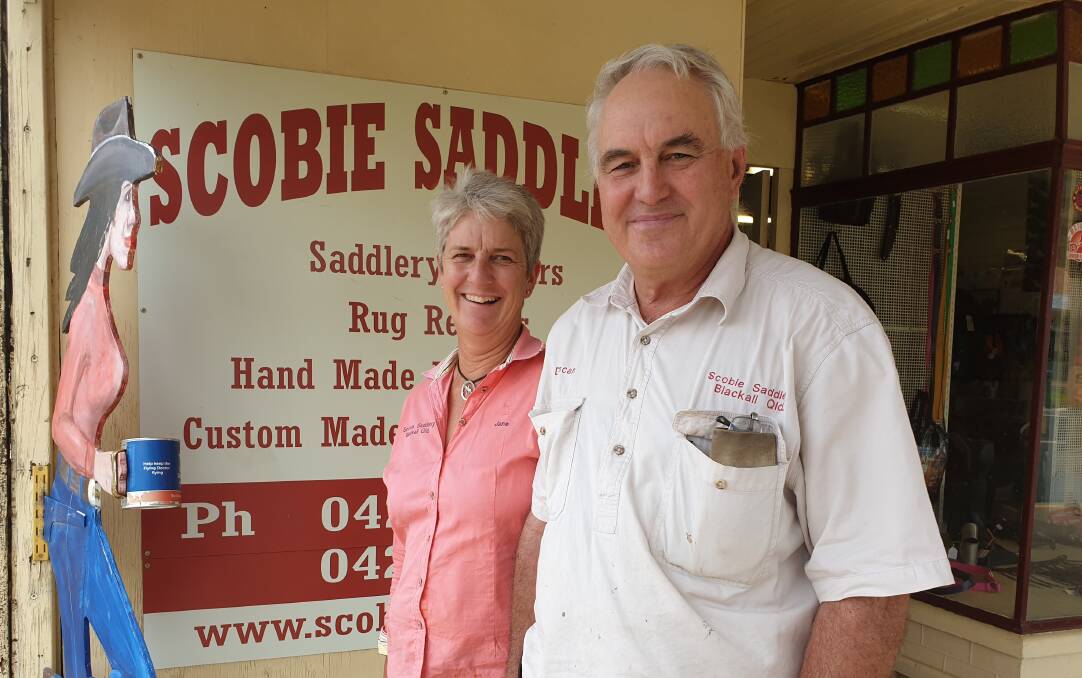 Jane and Duncan Scobie outside their Blackall shop with its familiar mascot.