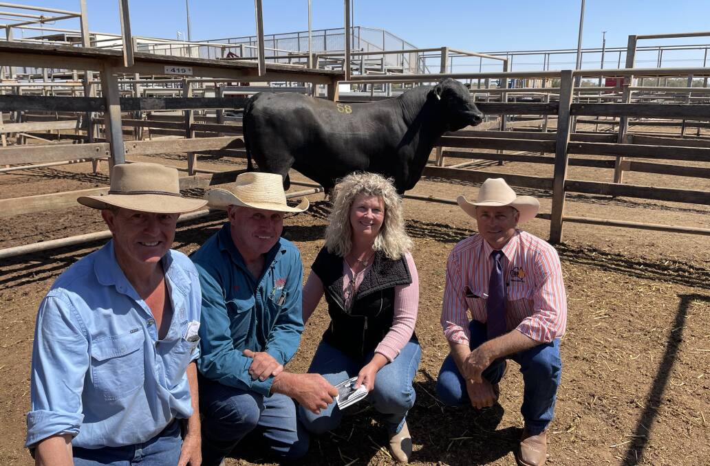 Pathfinder Angus principal Nick Moyle with top price buyers, Gary and Lynda Johnson, Dulacca Transport, Dulacca and auctioneer Cyril Close. Pathfinder Garth Q1155 sold for the sale top of $25,000. 