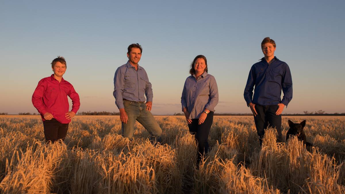 Wee Waa farmers Corie and Nicole Piper with their sons Ewan and Lucas and dog Max on their 'Auburn' property.