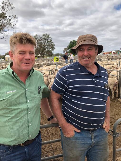 Andrew Bell, from Landmark Albury, with Mark Rhodes, Daysdale, who sold 165 shorn lambs for $174.