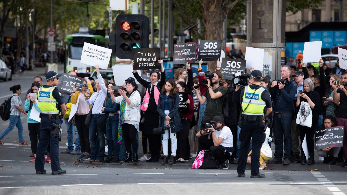 Animal rights protesters block a major Melbourne CBD intersection on Monday. (AAP Image/Ellen Smith)