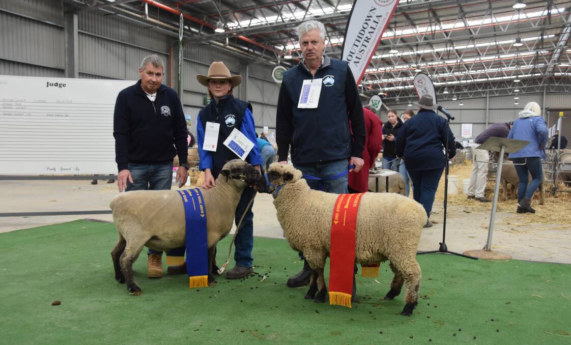Judge Andrew Beard with grand champion ram held by Harrison Gurnett, Gunyado, Kerang, and reserve champion ram held by David Pickles, Holbeck Park, Huntly. Picture by Elizabeth Anderson