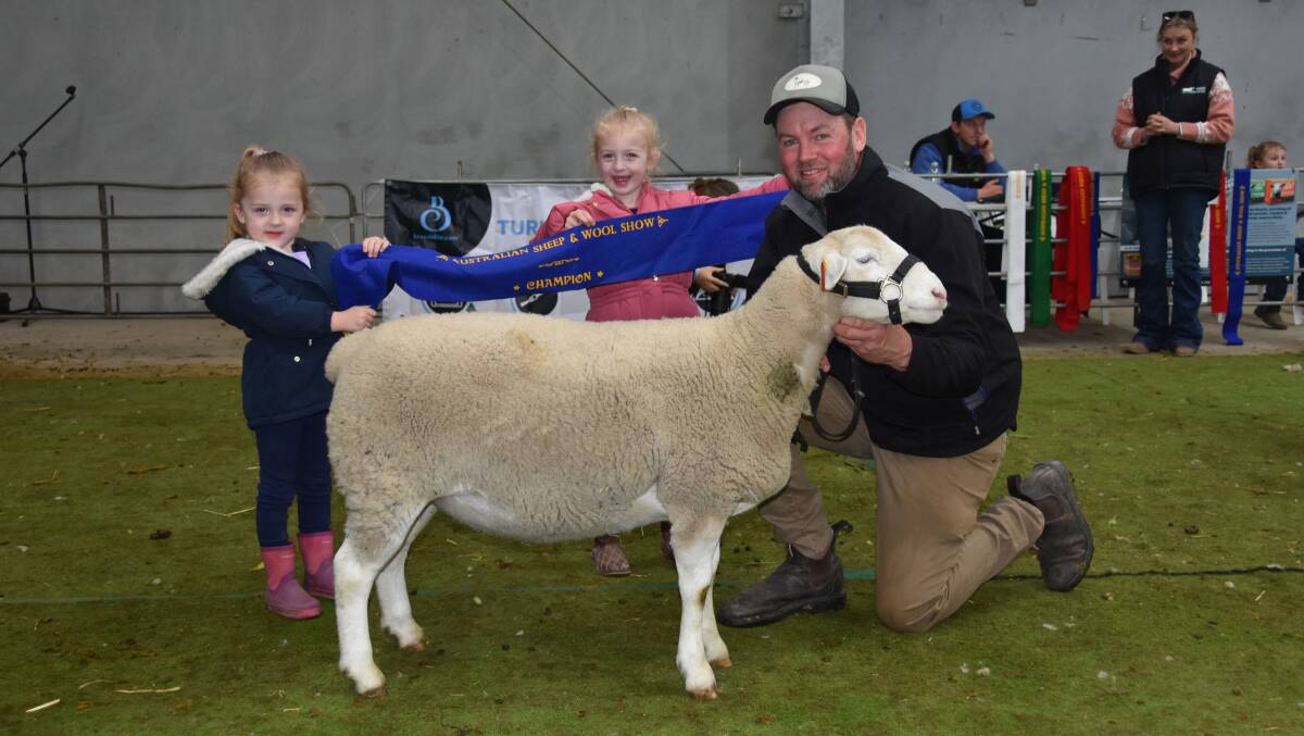 Laylah, Holly and Guy Treweek, Induro, Wakool, NSW, with the champion Ultra White ewe.