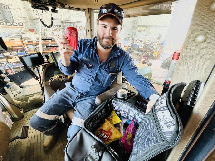 CHEEKY: Farmer and TikTok sensation Tim Barndon holds up the sneaky Coke that is always a talking point in his daily lunch box documentaries. With seeding underway he will be in the tractor cab a lot in coming weeks.