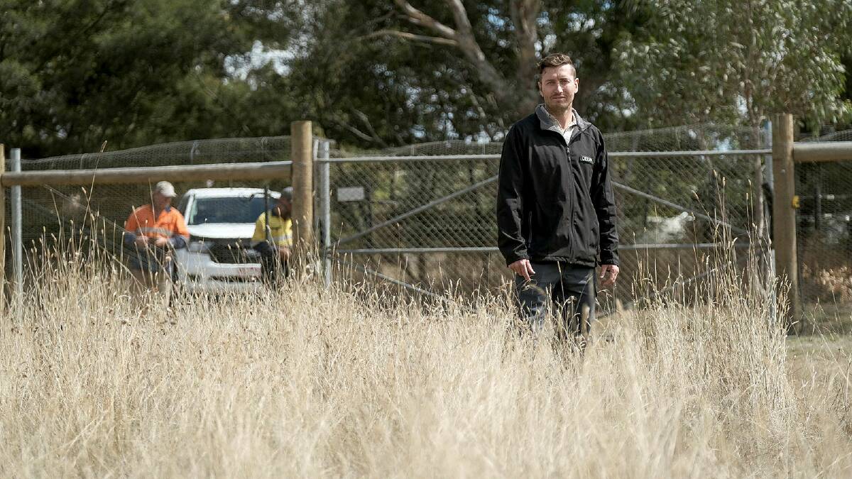 Department of Environment, Land, Water and Planning natural environment program officer Jonathan Lee at the new predator-proof fence at Hamilton Sanctuary. 