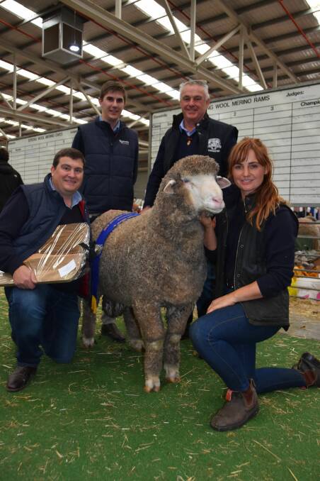 Ross and Claire McGauchie, Terrick West, Prairie, and Rodwells wool manager Michael Dekleuver with wool graduate Damien Dore holding  the Australian champion all-purpose Merino exhibit. Photo Catherine Miller. 