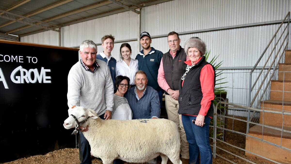 RECORD: Top-priced ewe, Lot 49, with Murray Long, Pendarra White Suffolks, Ardlethan, NSW, Detpa Grove stud principals Michelle and David Pipkorn, Elders' Ross Miline and Trish Betts, Ardlethan, (front) with Jordan, Sophie and Alex Pipkorn (back). 