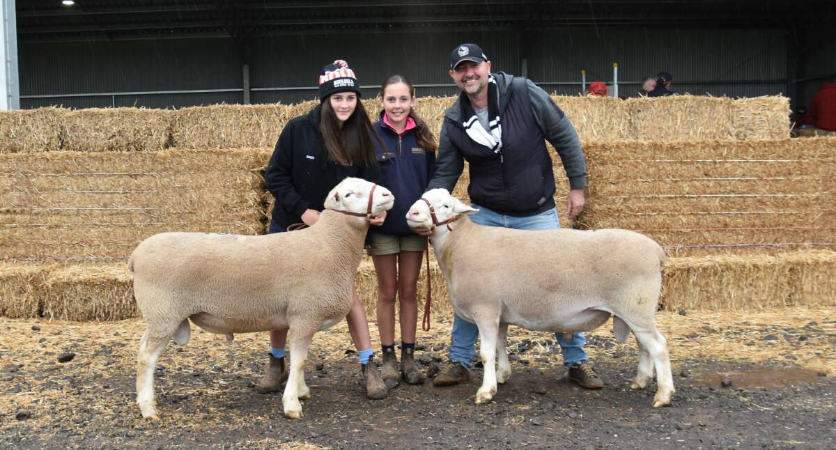 Rory and Remi Baker, Booloola, Baringhup, and buyer of the top-priced lot Martin Harvey, Paxton stud, Western Flat, SA, with the two rams he purchased, including the top-priced ram is on the right. Picture by Alastair Dowie