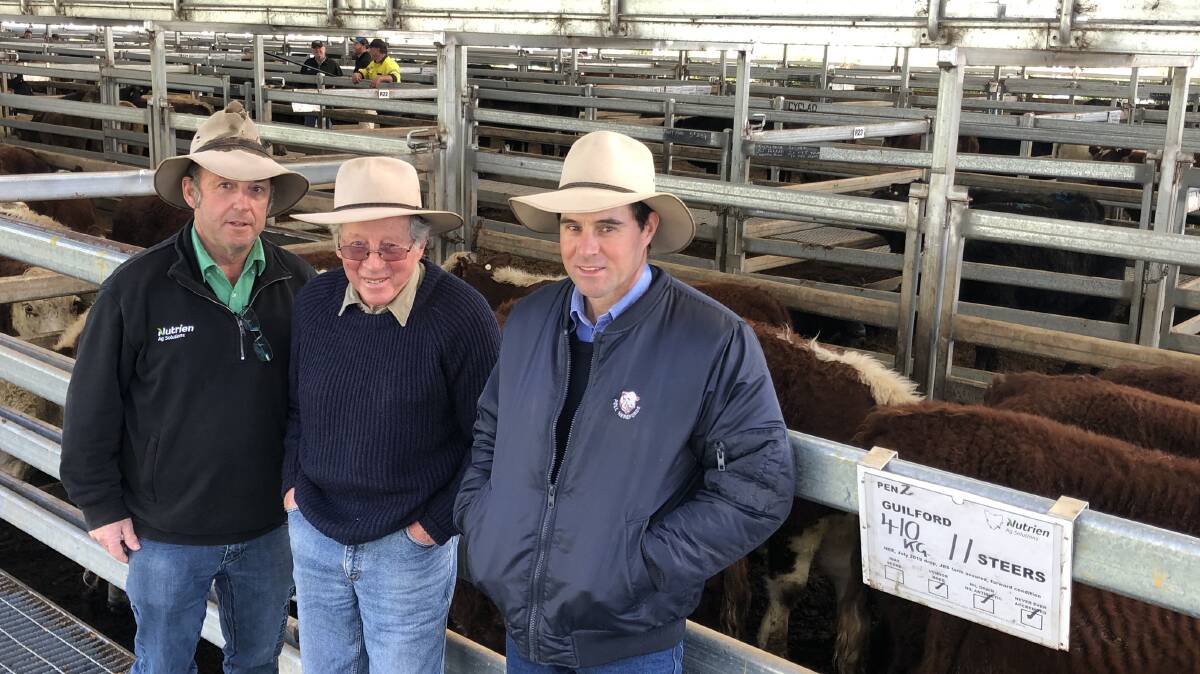 SOLD: Nutrien Livestock agent Rodney Batchelor with clients Bert and Philip Davies, Guilford, Ouse, Tasmania, with a pen of 11 of their steers, 410kg, which made 412c/kg or $1690 at Powranna.