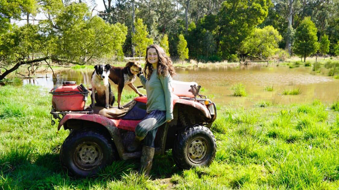 CREEK IS 'PUMPING': Beef farmer Poppy McBain, Kennedys Creek, with dogs Clancy and Beth, says more than 100mm of rain fell at her farm near Simpson between Wednesday and Sunday.