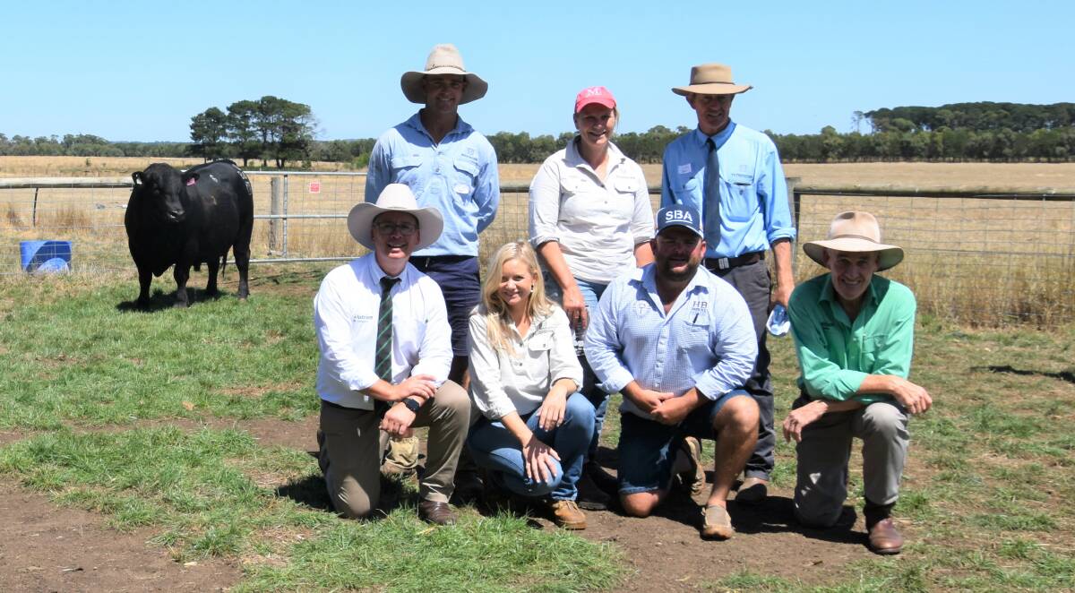 Darcy Lewis and Sara and Nick Moyle, Pathfinder Angus, and (front) Nutrien auctioneer Gordon Wood, Elle Moyle, Pathfinder Angus, buyer Heath Tillere, Goolagong, Crystal Brook, SA, and Trevor Driver, Nutrien, with the $50,000 Pathfinder Angus bull.