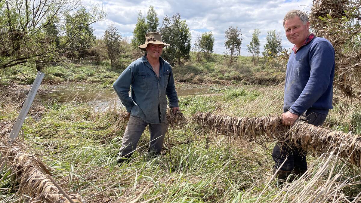 Newry dairy farmers Peter Neaves and Tim Dwyer assess the damage after 58,000 megalitres was released from Lake Glenmaggie last week. Picture by Bryce Eishold