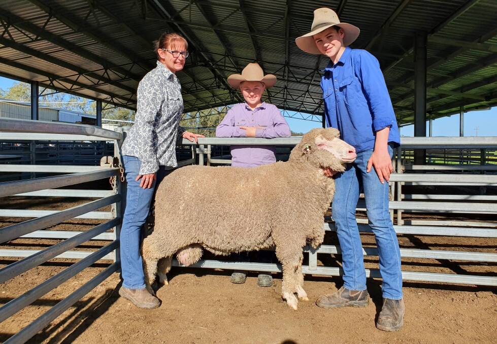 LOOKING GOOD: Toland Merino stud principal Anna Toland with Matilda and Charlie and one of the top-priced $7800 rams.