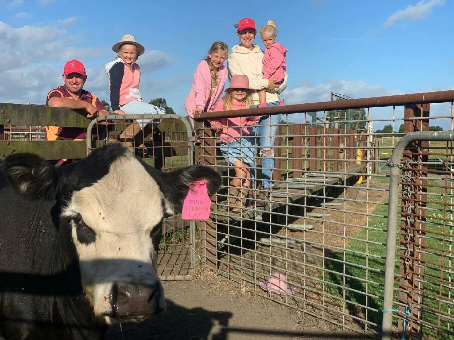GOOD CAUSE: Leongatha South farmers Russ and Amy White with their children McKenzie, Lacy, Charlie and Harper and one of the charity pink stumps heifers set to be sold at auction this month.