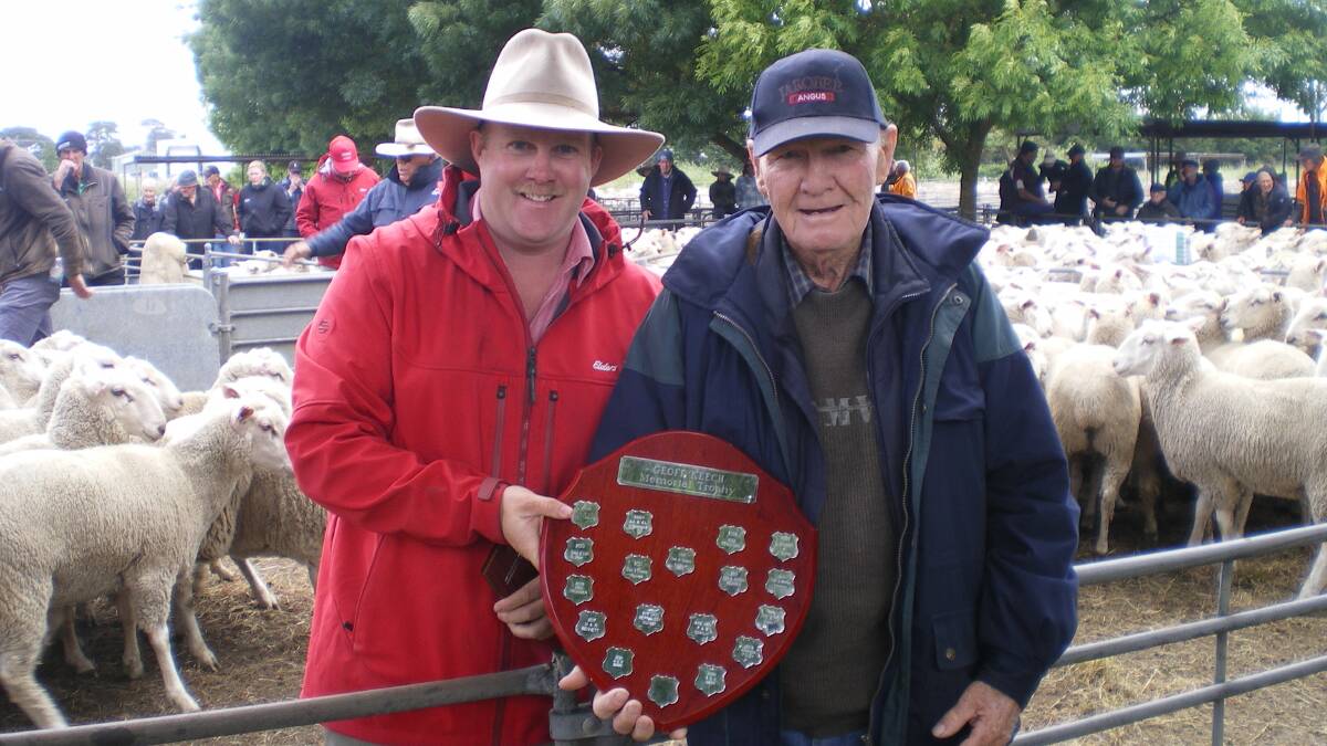Elders Kyneton livestock manager Dean Coxon and Ken Kelly, Myrtle Creek, who won the Geoff Keech Memorial Trophy pen of ewe lambs which sold for $260 during the first-cross Border Leicester/Merino-cross ewe sale at Kyneton. Photo by Larina Strauch.