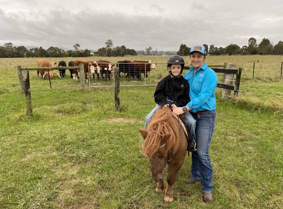 ONLINE: Bairnsdale's Carlee Knight raises money for the Dolly's Dream Foundation with the future in mind, raising awareness of online bullying and mental health issues. Pictured with son Jack, 7 at their East Gippsland property.