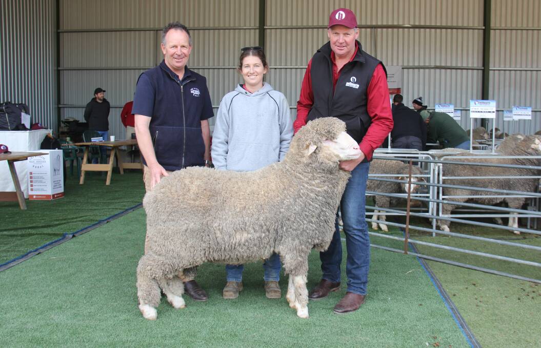 Andrew Hendy, Fox and Lillie Rural, Horsham, buyer Hayley Reading, Bryn Avon, Callawadda, and Belbourie Merino & Poll Merino stud principal Paul Hendy, Marnoo, with the highest-priced ram. Photo by Peter Marland, North Central News.
