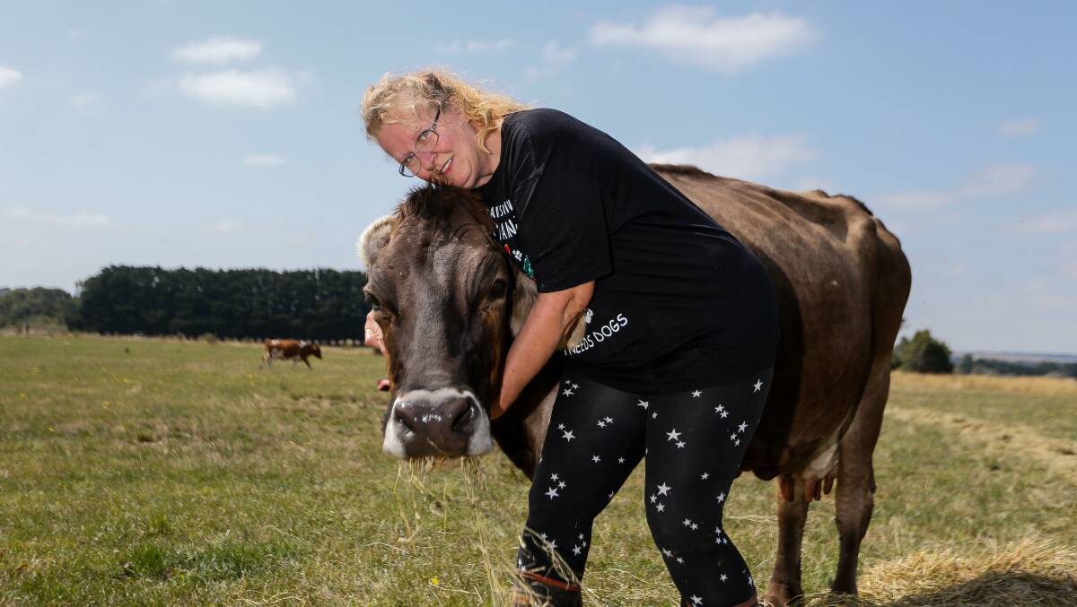 Gaylene Childs snuggles with one of her favourite cows on the farm. Photo by Anthony Brady.