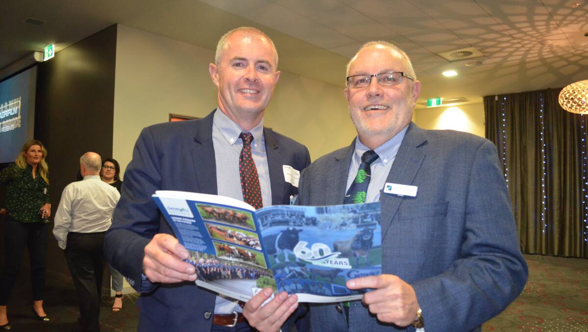 HISTORY: Genetics Australia chairman Trevor Henry and long time staff member Robert Derkson, review the booklet launched to celebrate 60 years of the coop.