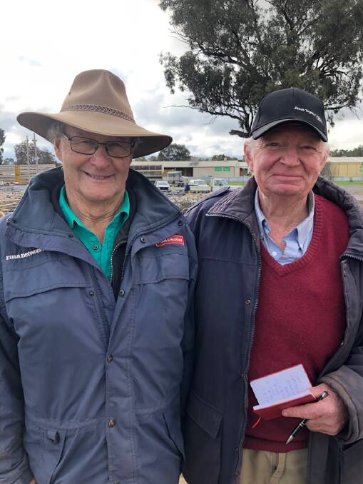EWE SALE: Sam McCulloch from Paull & Scollard/Landmark Culcairn, NSW, with Andy Dunn from Weebo Park Bungowannah, NSW, who sold Merino ewes to $165 at Corowa.