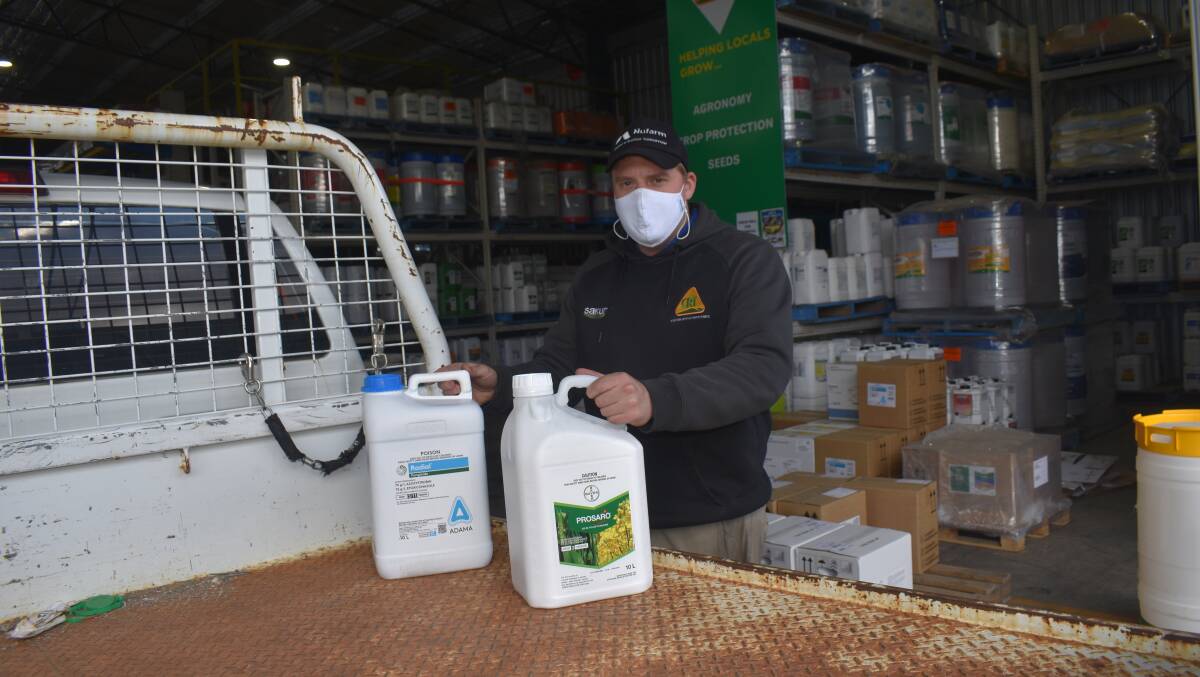 CONTACTLESS: Crameri's Mitre 10 and CRT rural merchandise sales representative Trent Mortlock masked up preparing for farm deliveries conducted with no contact.