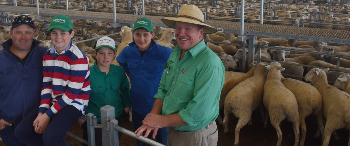SALE DAY: Moonlight Flat's Phil Davies with sons Jack, Max and Ben, along with agent John Wagstaff, Nutrien Ag, at Ballarat with his lambs that averaged $220.