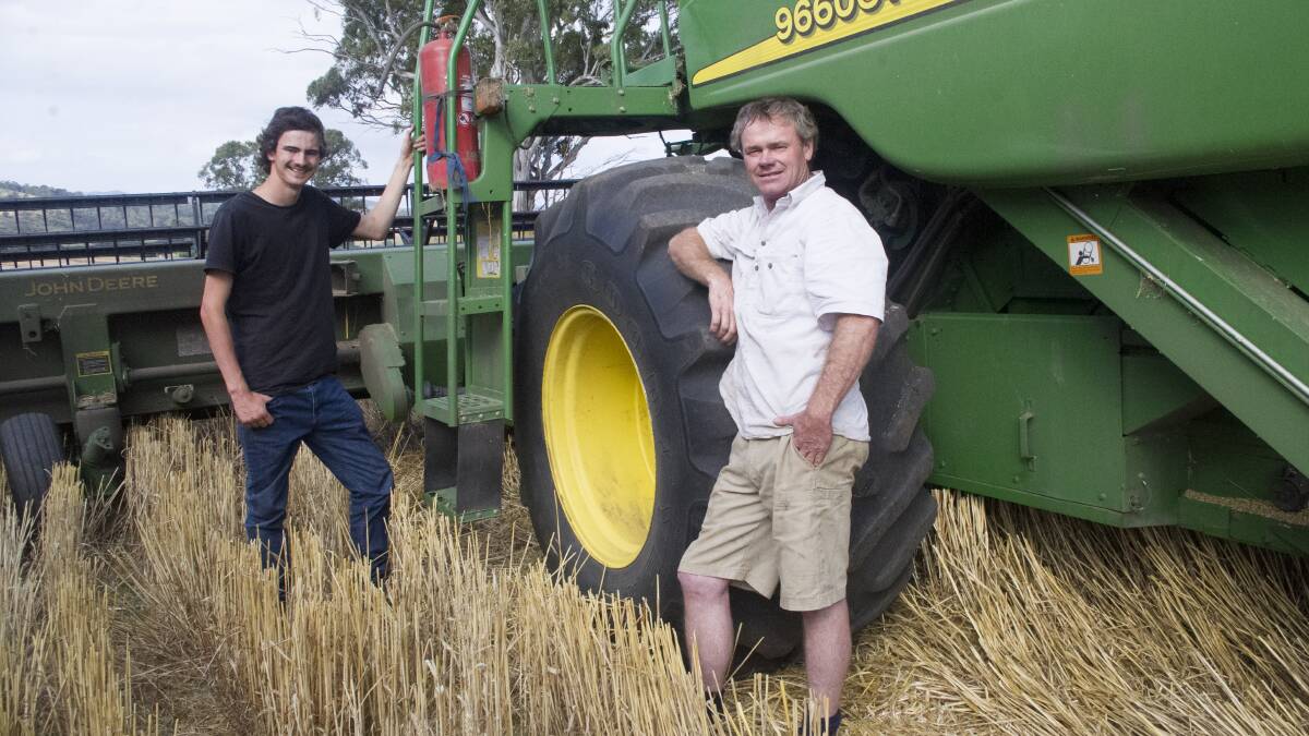 Ross and David Shaw during harvest at Glenmaggie in East Gippsland. The dry conditions have seen the family's emphasis change from crops to turning off more lambs.
