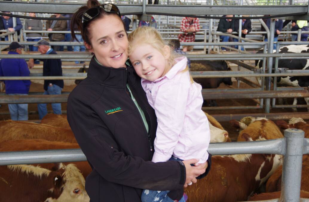 Landmark’s Sam Platts, pictured with Evie Filtmess (4) at Bairnsdale on Friday, was overseeing the sale of Hereford steers and cows and calves from JF&CF Coman, Delegate, C Trevanion, Bombala and Holley Ridge Pastoral Co, Delegate.